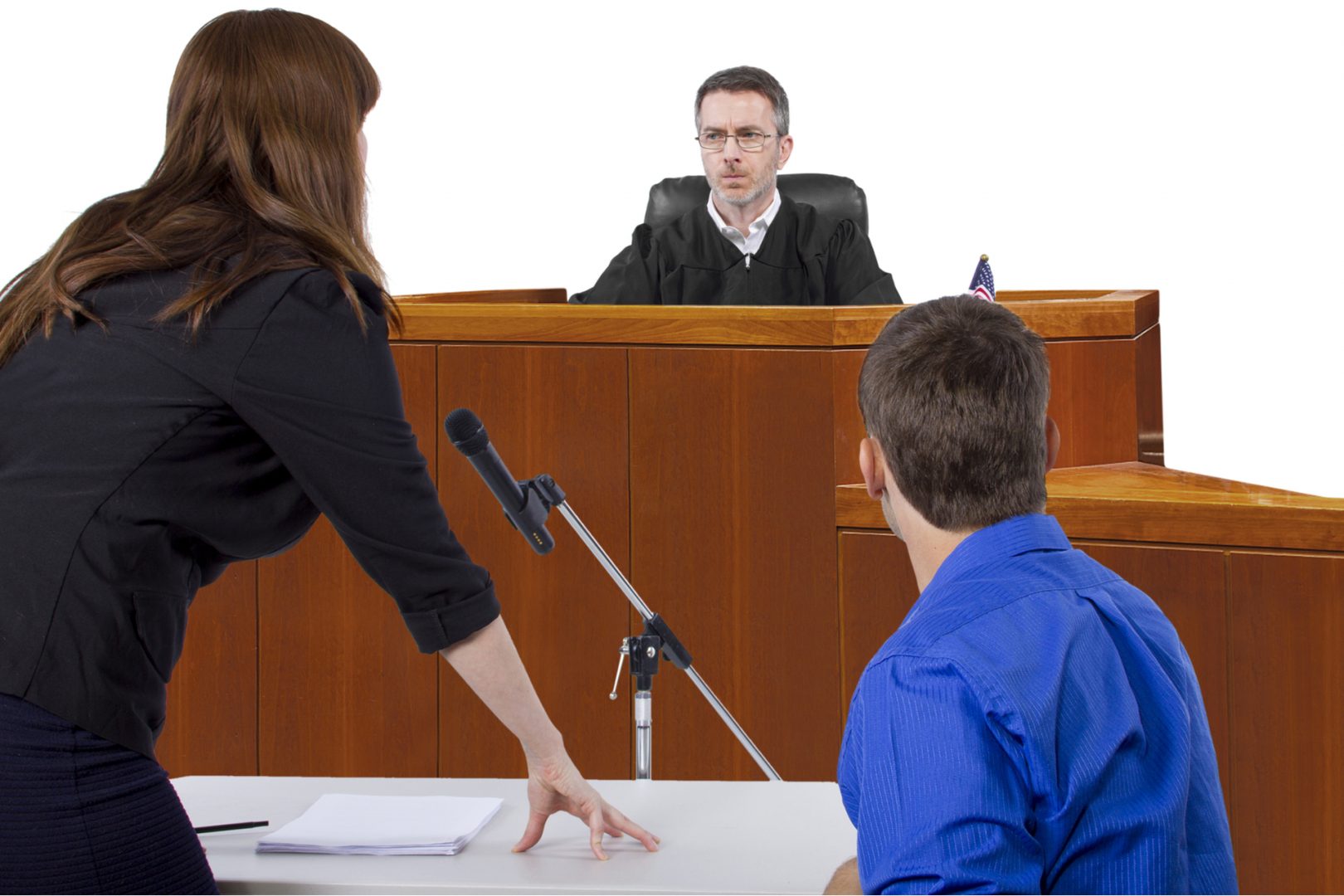 defendant with lawyer speaking to a judge in the courtroom