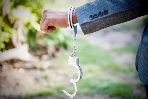 Man's fist with one handcuff on it